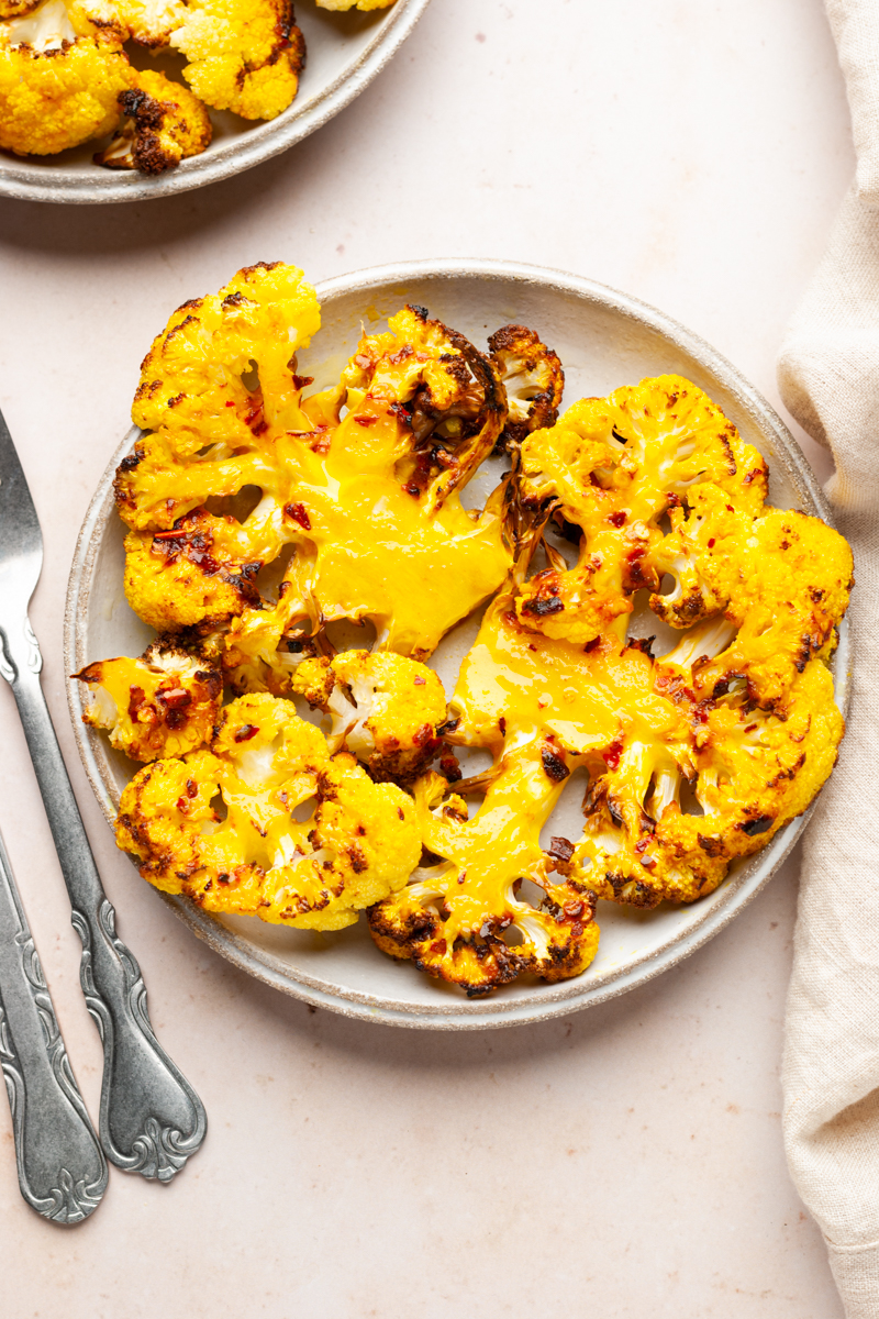 Crispy air fryer cauliflower steaks on a plate. 