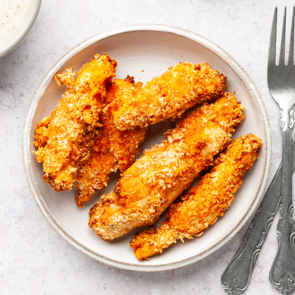 Air fried buffalo chicken tenders on a plate.