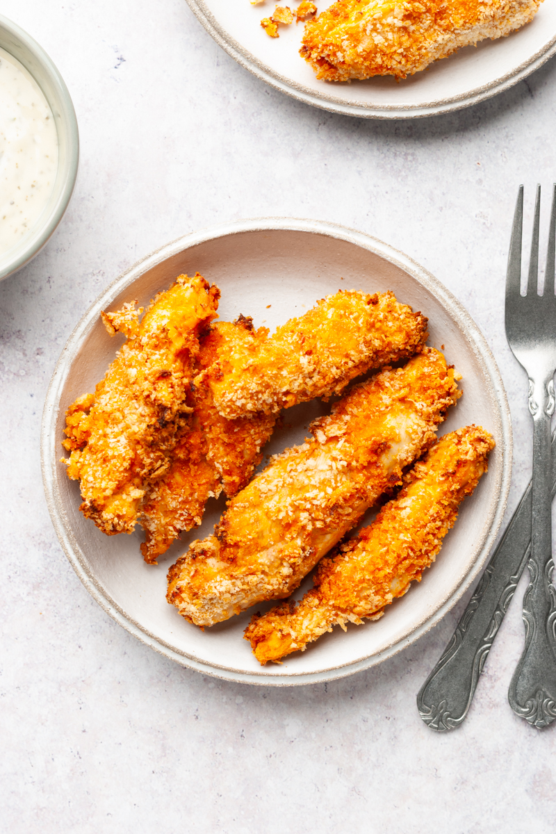 Air fried buffalo chicken tenders on a plate. 
