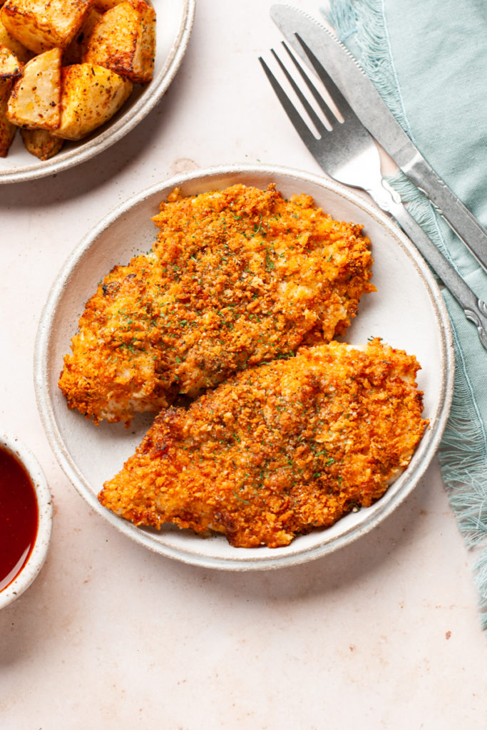 air fryer parmesan crusted chicken breasts in a plate