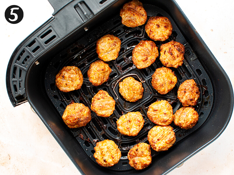 Cooked chicken meatballs in air fryer.