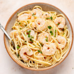 shrimp scampi without wine in a bowl with a fork.