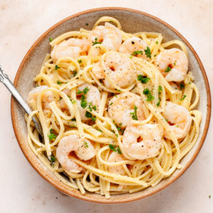 shrimp scampi without wine in a bowl with a fork.