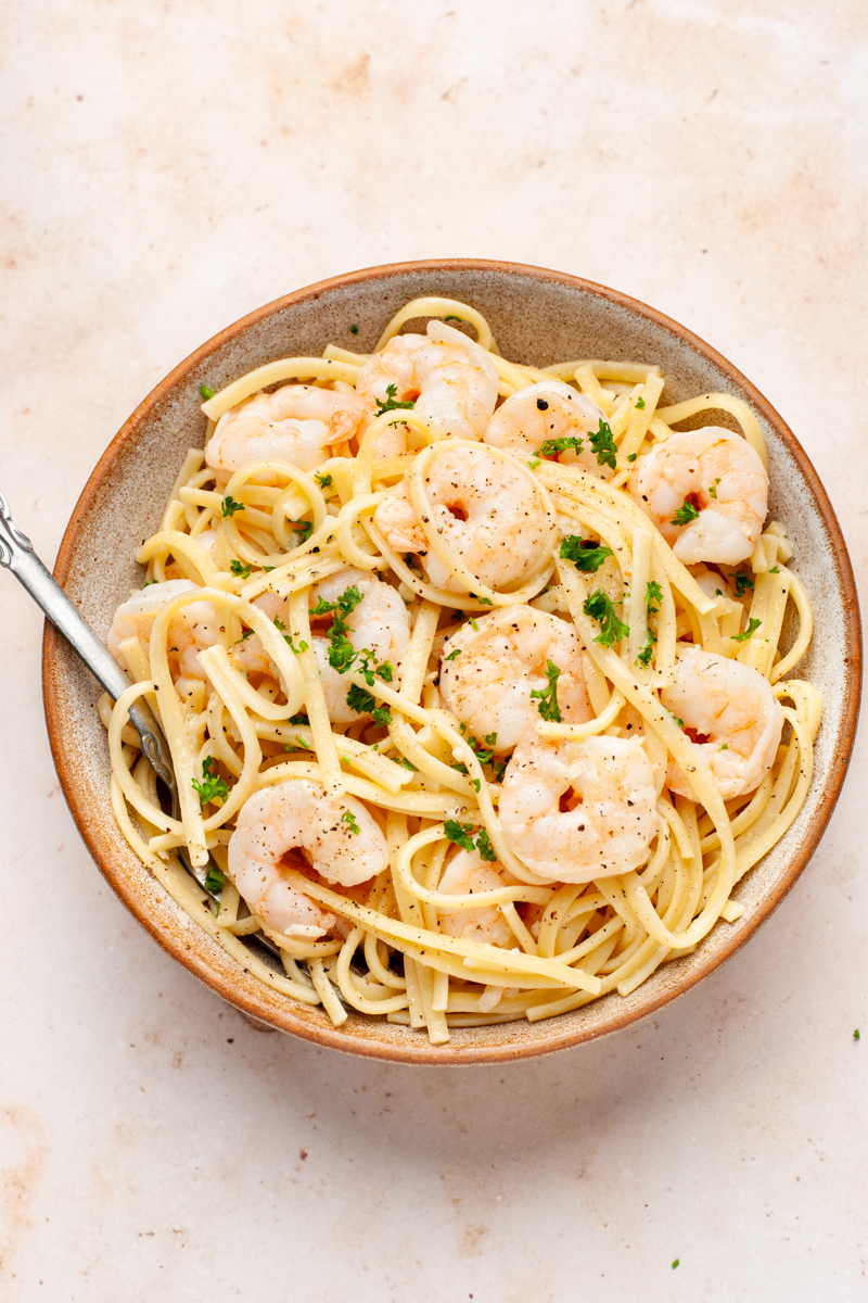 Shrimp scampi with linguine pasta in a bowl with fork. 