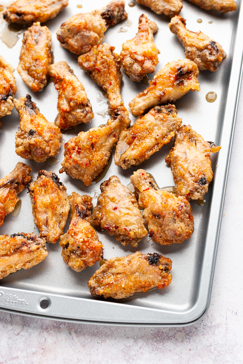 Honey garlic chicken wings on a sheet pan.
