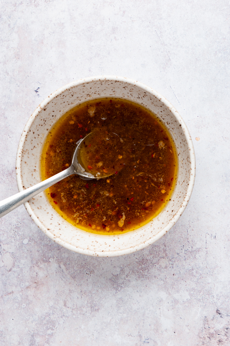 honey garlic sauce in a small bowl with a spoon