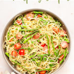 Pasta primavera with asparagus and peas in a pan.