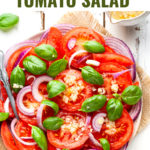Italian tomato salad in a platter with a fork.