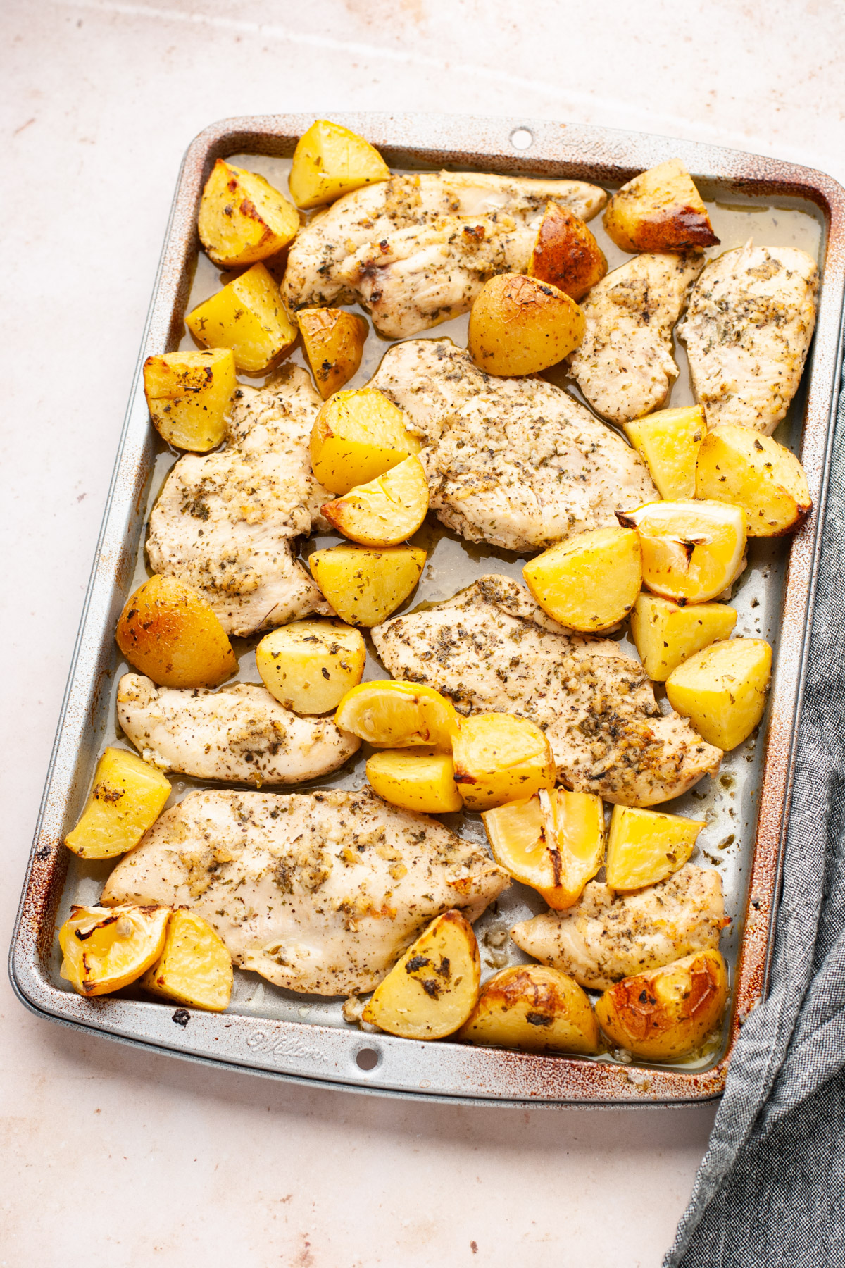 Lemon chicken and potatoes on a sheet pan.