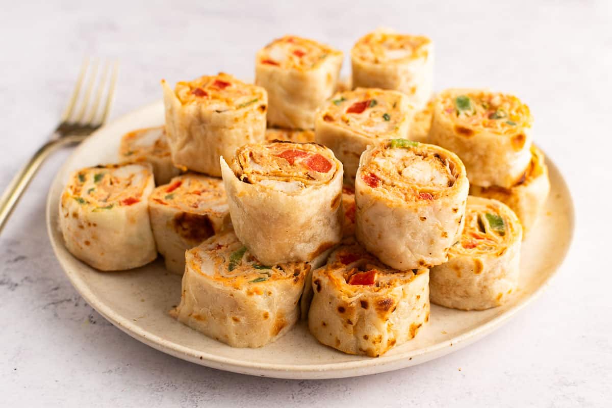 Mexican pinwheels (chicken) piled on a plate.