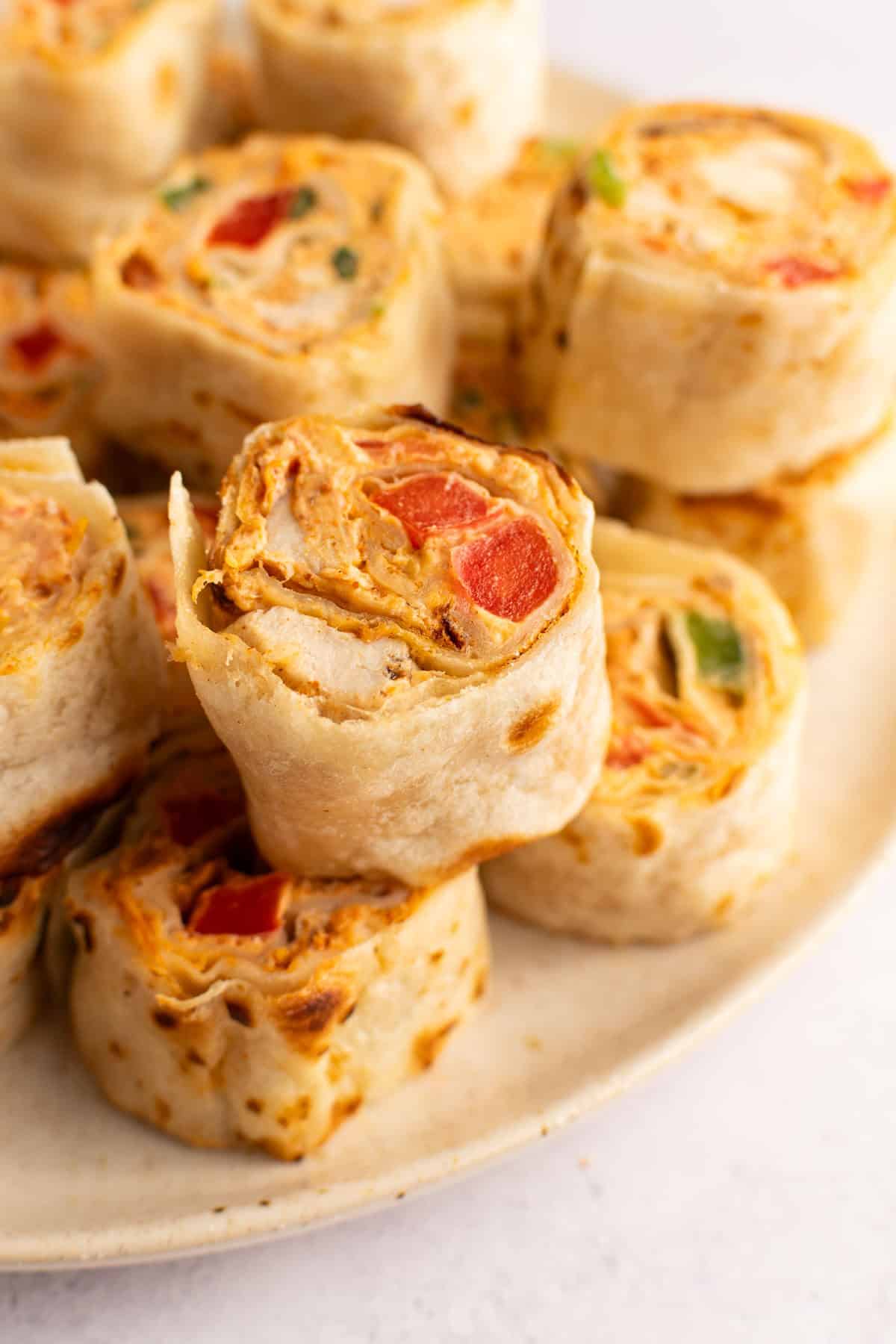 Close-up of Mexican chicken pinwheels on a plate.