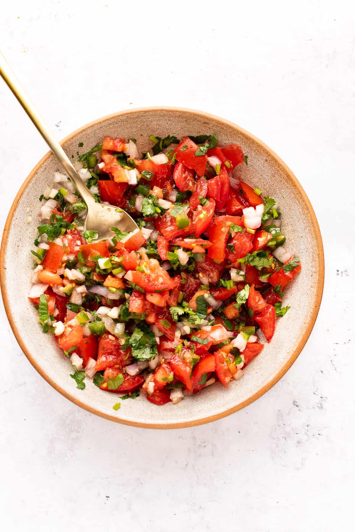 Pico de Gallo in a bowl with spoon.
