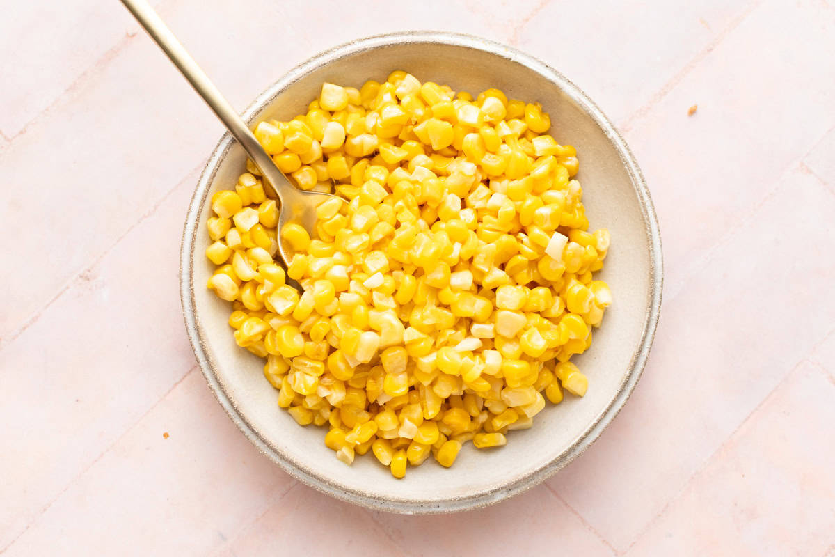 Roasted corn kernels in a small plate.
