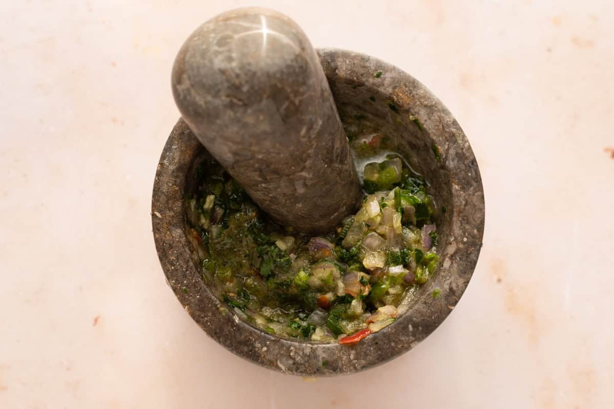 Chopped onions, tomatoes, jalapeno, garlic and cilantro - smashed in a mortar with a pestle.