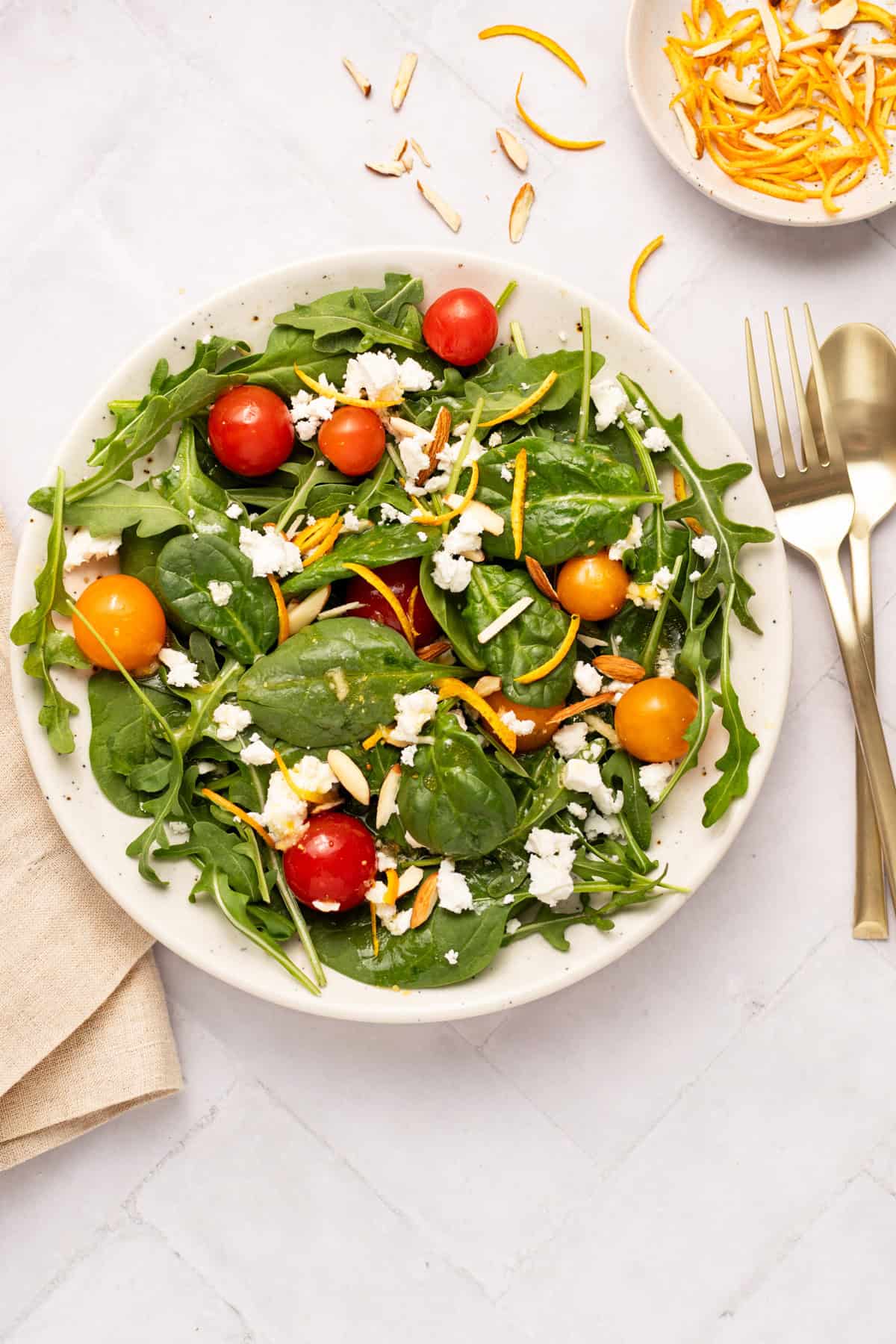 Spinach and arugula salad in a round platter.