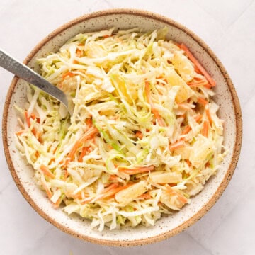 Angel hair coleslaw with pineapple in a bowl.